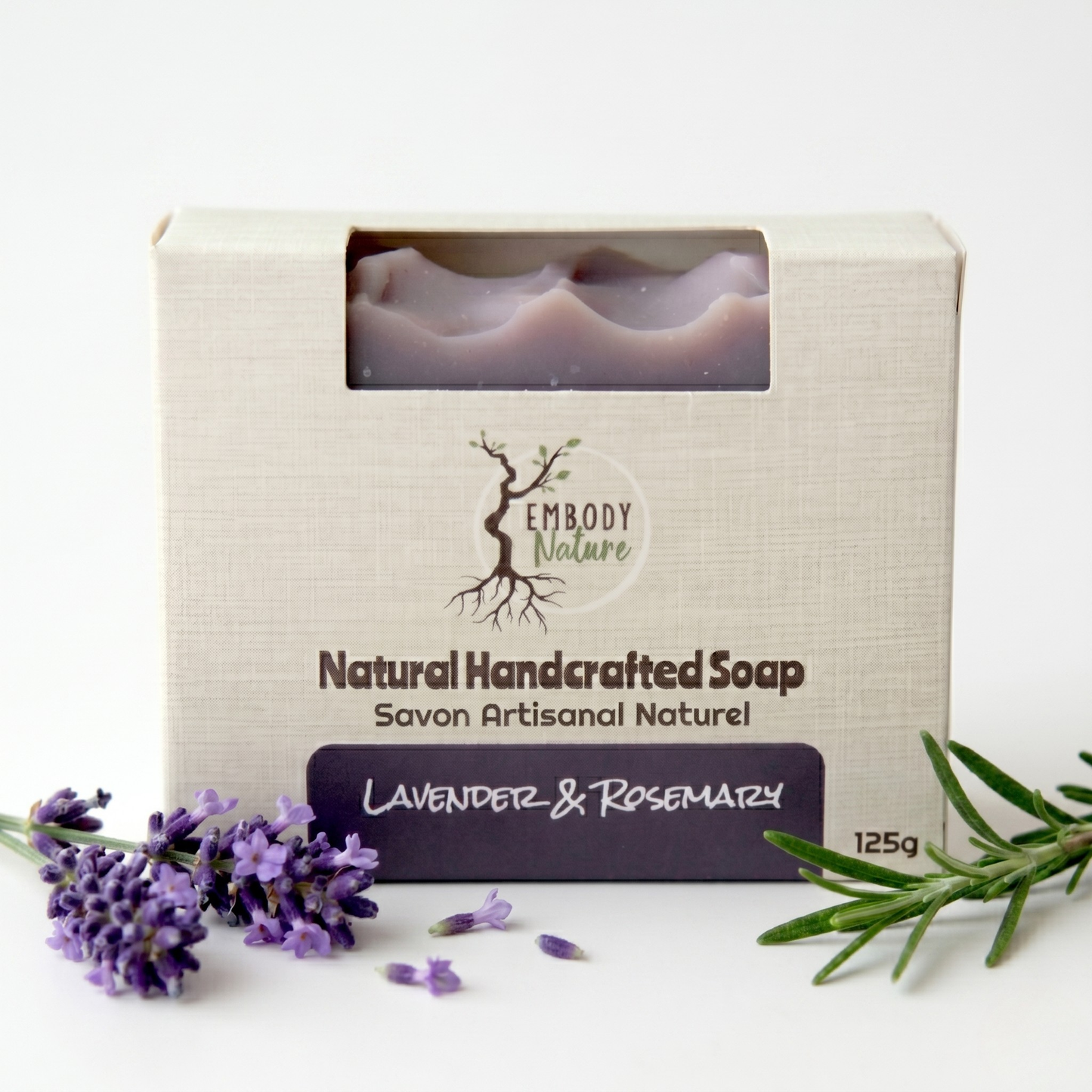 Natural handcrafted Embody Nature's soap in a box with lavender and rosemary on a white background