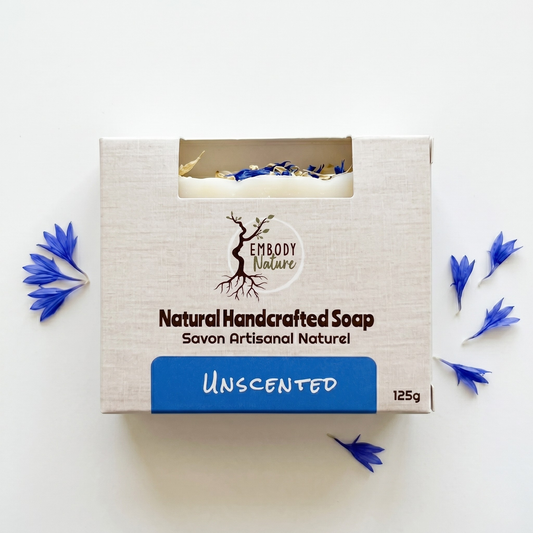 an unscented all natural handcrafted soap bar by Embody Nature, clear white background with ccents of blue cornflowers